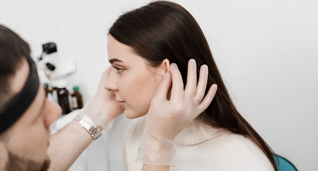 Doctor examining a patient's earlobe